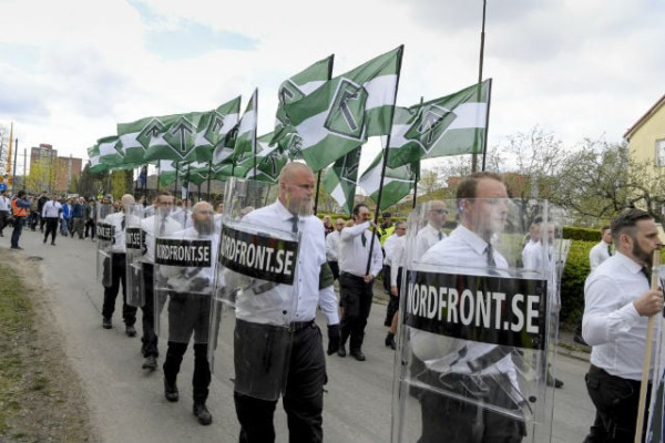 Swedish neo Nazi group NMR marching with police protection. 