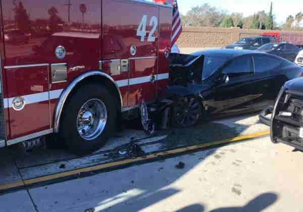 Photo of a Tesla that crashed into the back of a fire engine while using auto pilot killing the driver.