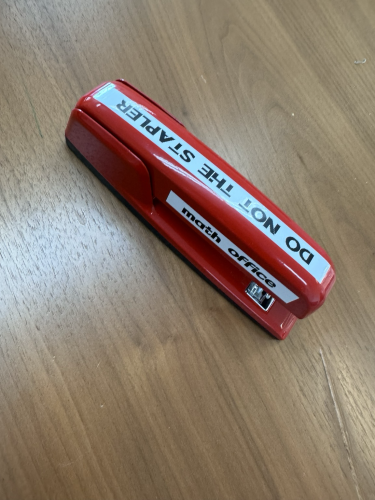 A red swingline stapler labeled “math Office” and “do not the stapler “