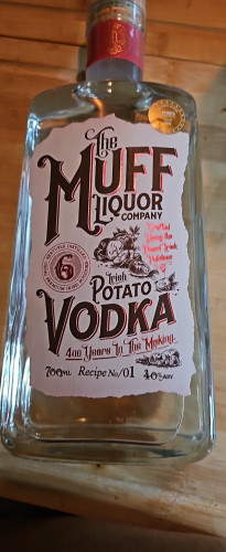 A photo of a clear glass bottle of vodka labelled "The Muff Liquor Company" "Irish Potato Vodka" "400 years in the making"