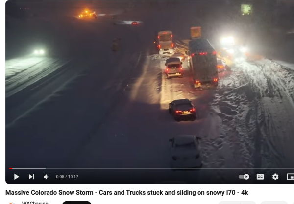 Semis and cars stuck in very deep snow on the I-70