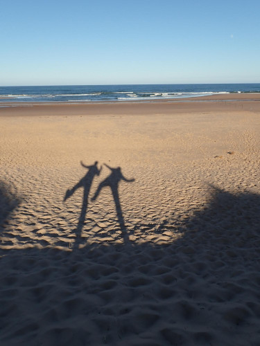 Shadows of us two from the low evening sun. On the sand leading to the sea beyond. It was a lovely evening. We are messing about a bit.