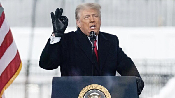 Photo: President Donald J. Trump addressing the mob that he sent to the Capitol Building on January 6, 2021. In this photo, Trump is on the dais, telling his lies about the “stolen” election. He’s making the “Wp”/“White power” gesture with his right hand. 