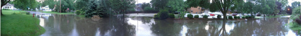 A neighborhood in Madison, in panoramic view, showing the street entirely flooded.

One of our neighbors ended up driving into that not knowing how deep it was and losing their car (engine damage made it a total write-off).