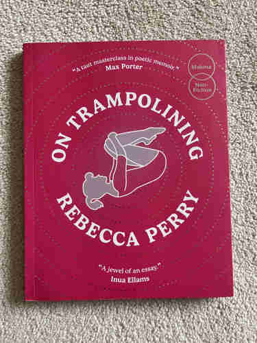 Cover of On Tranpolining by Rebecca Perry. Cover is magenta, and features an image of a young girl, tucked in a spin