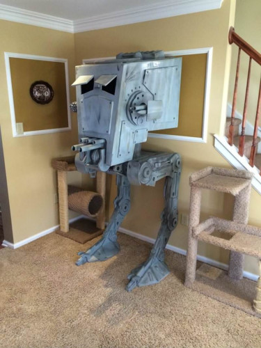 a miniature scale model of an imperial AT-ST walker inside a house. 