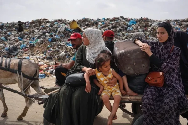 Palestinian women and children flee Rafah with their belongings on a donkey cart following renewed Israeli strikes in the city in the southern Gaza Strip on May 28, 2024 [Bashar Taleb/AFP]