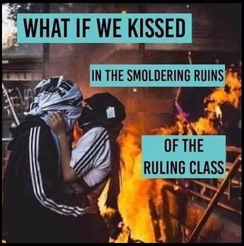Two masked and hooded people kiss in front of a burning building. 
What if we kissed in the smoldering ruins of the ruling class?