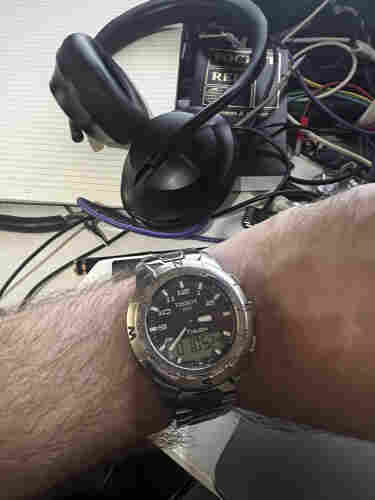 A man's arm with a watch on it, it's a Tissot T-Touch.