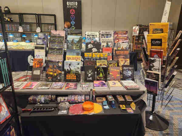 Close up of Three Dog Quest booth of Indie RPGs at DunDraCon 2024 in Santa Clara, CA

