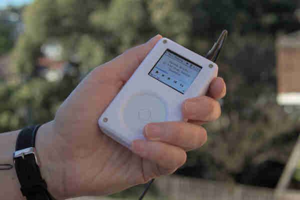 hand holding the Tangara mp3 player. The device is palm sized, with a small screen and a large scroll wheel. It sports a physical headphone jack.

https://www.crowdsupply.com/cool-tech-zone/tangara