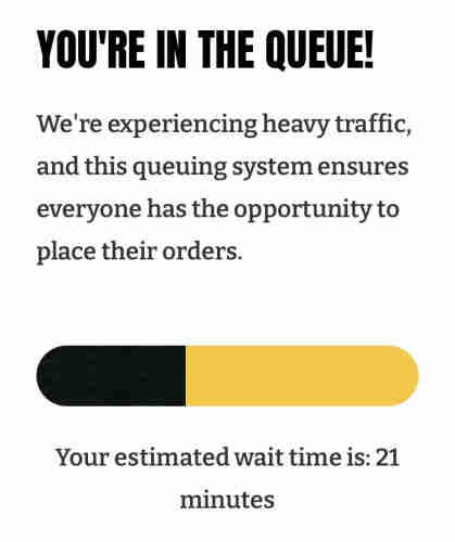 Queue notification screen showing heavy traffic message, queuing system information, and an estimated wait time of 21 minutes to access the Games Workshop website.