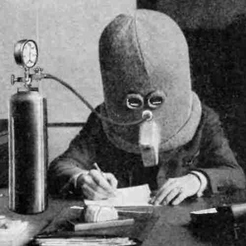 A picture of Hugo Gernsback in 'the isolator,' an anti-distraction dome that goes over his head.