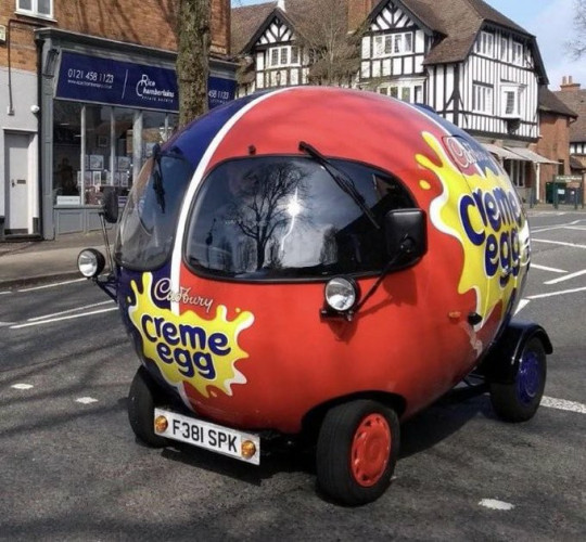 Small round red car that's a Cadbury creme egg 