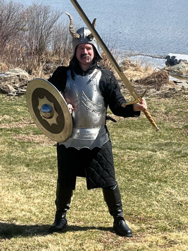 
Guy in horned helm with breastplate, shield, and sword.