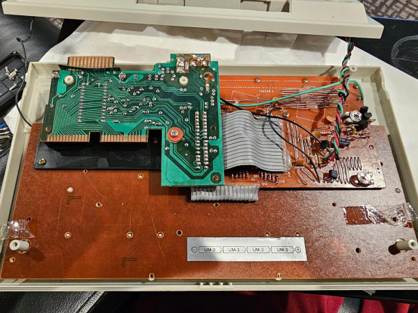 Inside of a vintage learning computer. Circuit boards are visible. 