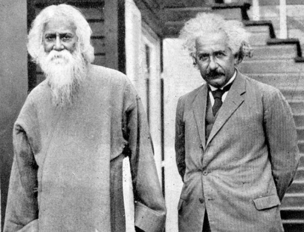 Rabindranath with Einstein in 1930. Einstein has his iconic mustache and wavy gray hair and stands with his hands behind his back. Tagore has long gray hair and long gray beard and is dressed in a long gown. By UNESCO - UNESCO Gallery, Public Domain, https://commons.wikimedia.org/w/index.php?curid=27489646