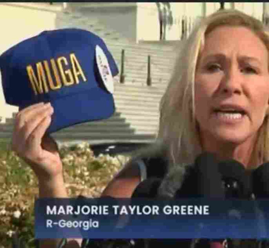 A blue hat with white MUGA lettering, held up by MTG