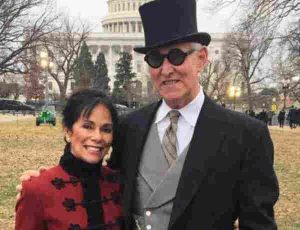 A photo of Roger Stone in a top hat and round sunglasses