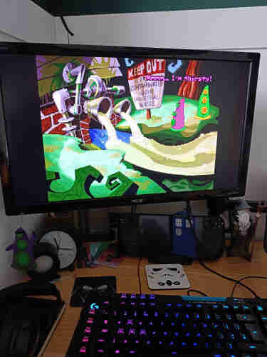 A picture of my desktop. Day of the Tentacle is showing on the monitor.