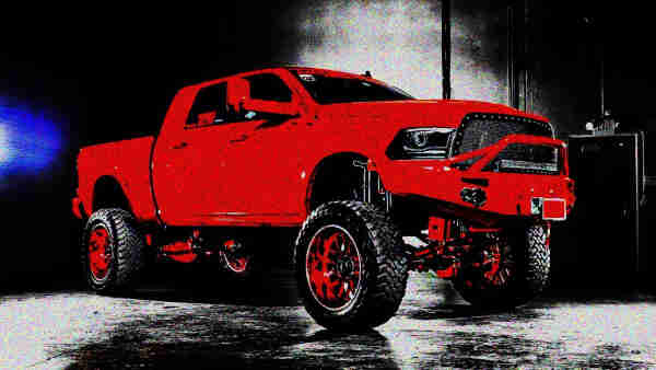 a high contrast photograph of a large red modified ford f150 ute, with a film gain filter 