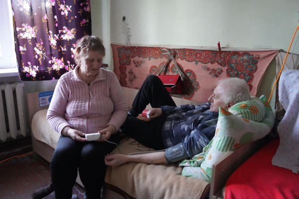 Halyna, 71, and her husband, Volodymyr, 71, fled their home in Kupiansk, Kharkiv, Ukraine, and sought refuge in Kremenchuk, Poltava region. When the couple arrived in a collective site in September 2022, it was in poor condition, but thanks to international donors and local NGOs, repairs were undertaken and new windows and doors were installed. The residents received new furniture in the rooms as well. The couple also received cash assistance from UNHCR, which is helping them to build a new life in Kremenchuk. [Alina Kovalenko/UNHCR]