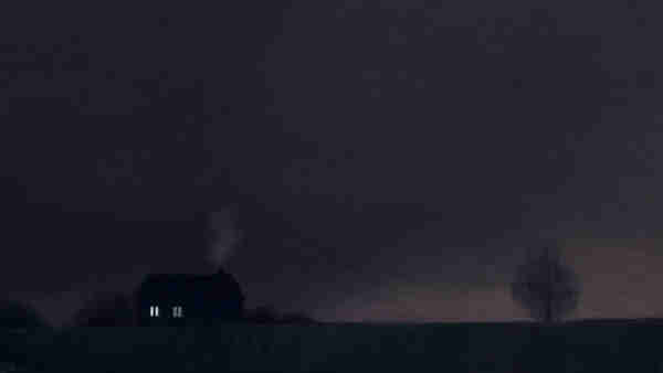 Digital painting of a small house in the middle of a field at night. Two of its windows are lit, and a little bit of smoke is coming out of the chimney. There are a few trees on the horizon. The sky is a cloudy dark grey.