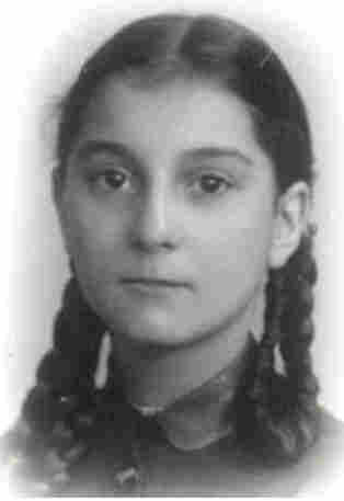 A photo of the face of a young girl with long braided hair.