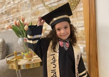 A school photo of 6 year old Hind Rajab wearing a graduation robe and mortarboard cap. 

Hind's extended family were murdered by IDF while evacuating via car in January. Hind initially survived - hiding with her dead family in the car - and telephoned, terrified, asking for help.

Red Crescent coordinated with IDF to travel to Hind and bring her to safety - 
instead IDF murdered the medics on arrival... and IDF murdered 6 year old Hind...
