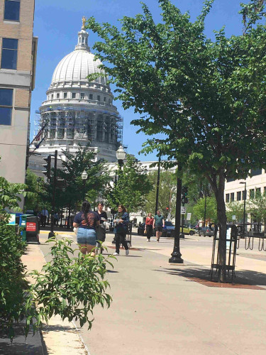 Picture of the capital building in madison Wisconsin from king street with scaffolding around it