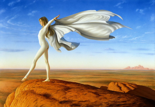 At cliff's edge, a preteen girl with long blonde hair poses in white ballet leotard. She lifts one foot while holding arms out wide. White cloth flows behind her, billowing in the wind, to take the shape of wings. The edge of the cliff rounds as it drops off. Beyond the pitted orange rock is blue sky traced with arcing wisps of clouds and mottled desert scrubland
