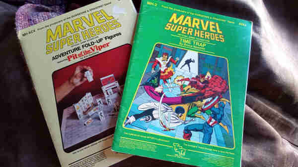 Copies of supplements from the 1980s Marvel Super Heroes Game, MH-2, Time Trap, and MH AC4, Fold Up Figures Featuring Pit of the Viper.