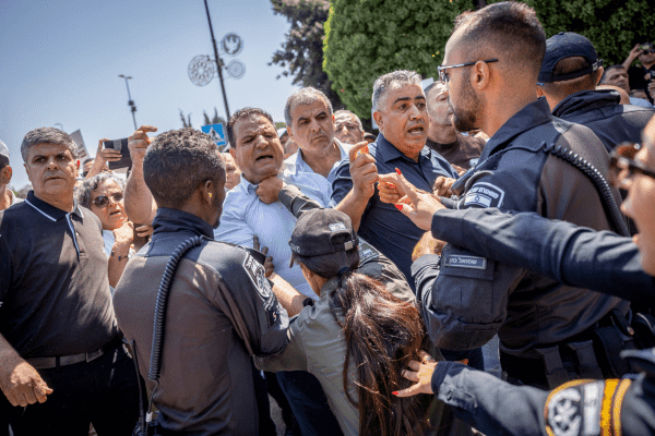 A strategy aimed at sending a clear message to Palestinian citizens in Israel. Police officers push MK Ayman Odeh during a protest in front of the office of Finance Minister Bezalel Smotrich, 

August 21, 2023 

(Photo: Yonatan Sindel/Flash90)