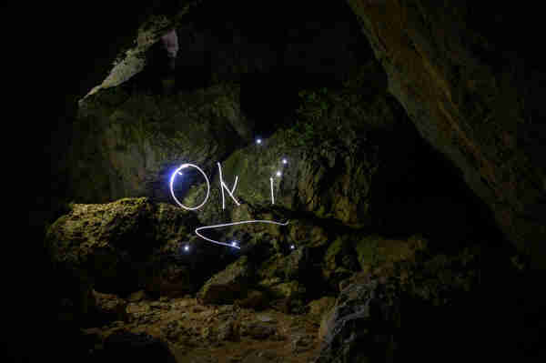Light painting that read Oki in a rocky enclave.