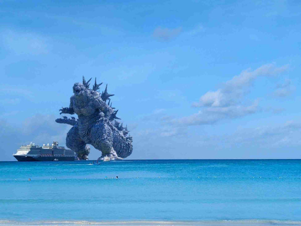 A picture of the Nieuw Amsterdam, the ship the JoCo Cruise is on, with Godzilla standing behind it