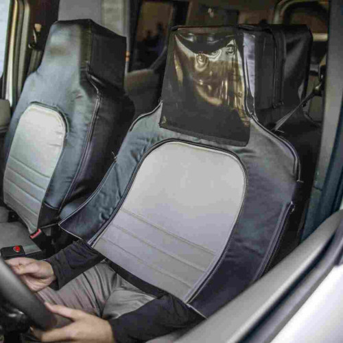 Inside of a car and you can see one person that's basically wears a costume that makes it look like a seat.