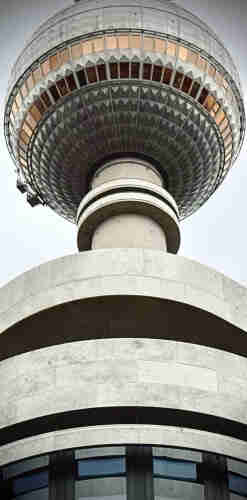 Close-up view of a tall tower with a spherical structure on the top and multiple circular tiers below.