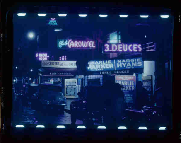 52nd Street jazz clubs signage: Club Carousel, 3 Deuces, etc, featuring Charlie Parker and others. Photo damaged by blue tint aging