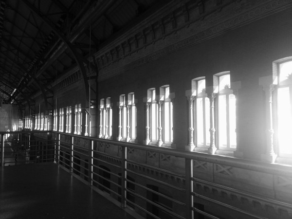 My photo of a row of windows from inside a large train station building with the light streaming in