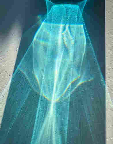 Blue pattern made by sunlight streaming through a blue water glass