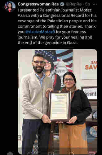 Congresswoman Rashida Tlaib awarding journalist for coverage in Palestine. Picture of her handing the award.