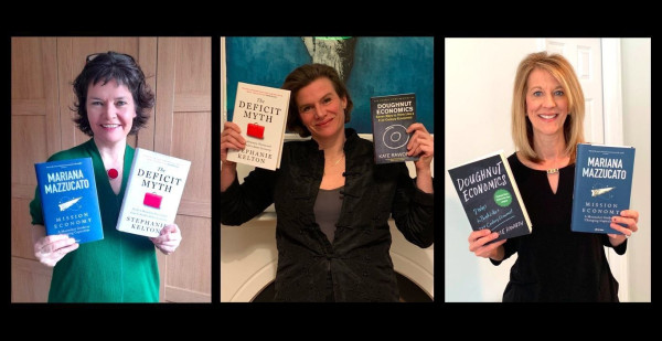 Kate Raworth, Mariana Mazzucato, and Stephanie Kelton each holding the other two's books: Mission Economy, The Deficit Myth, Doughnut Economics