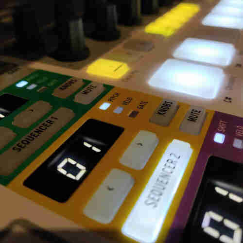 An Arturia BeatStep Pro sequencer with various yellow and white pushbuttons and pressure pads.