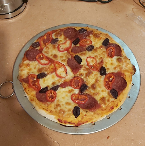 Photo of yummy pizza I made myself, straight from the oven,  with the toppings mentioned in the text. I wish you could smell it.