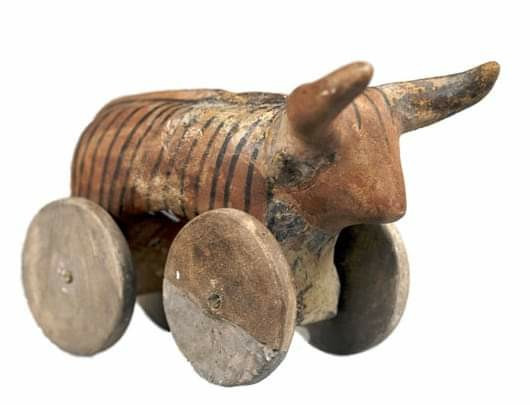 Wooden toy from 5000 BC from the Cucuteni culture of Modern Romania. It is a steer on wheels, with two large and pointy horn sticking straight out from its forehead.