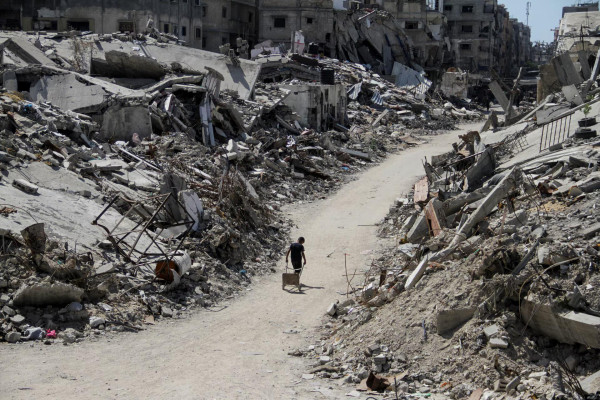 A Palestinian walks among the rubble of damaged buildings, which were destroyed during Israel's military offensive, in Beit Lahia in the northern Gaza Strip, June 12. REUTERS/Mahmoud Issa