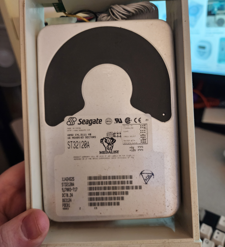 A Seagate hard drive in caddy: ST32120A, 2111 MB