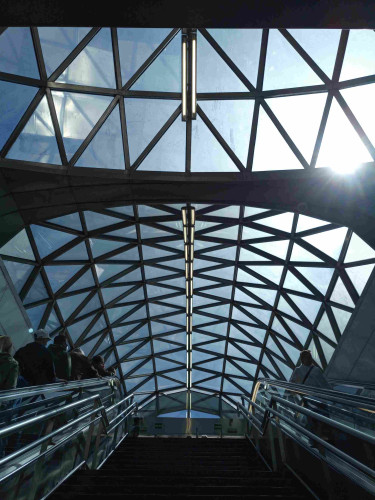 My photo taken from the inside one if the main exits of the metro station Sol in Madrid. The roof is made of many triangular windows in a dome shape.
