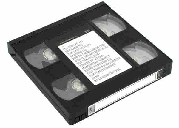 A picture of a vhs looking cassette on a white background. It appears to have four reels in it and who knows how that’s meant to work. It’s a pirated video with a number of movies on it with a nice typewritten label.