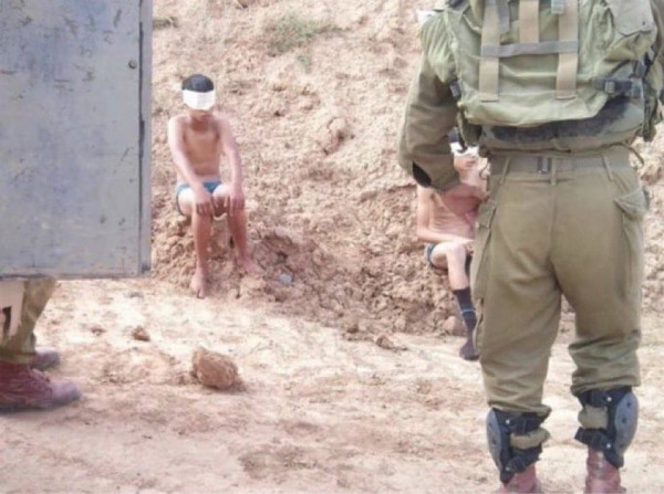 a palestinian child was stripped, blindfolded and arrested by IOF